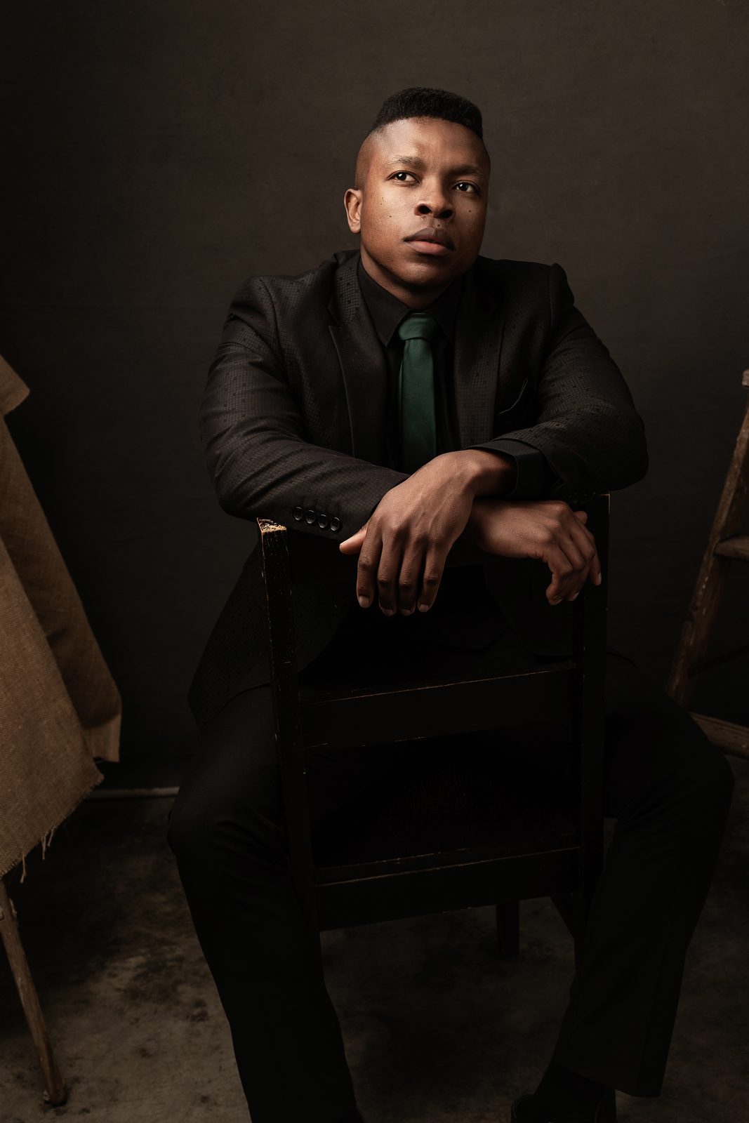 Studio portrait of Thuba Myeki in a dark suit