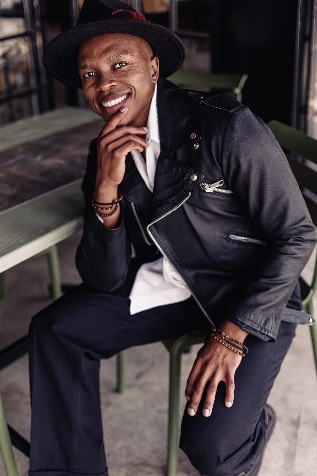 Thuba Myeki in a hat and leather jacket
